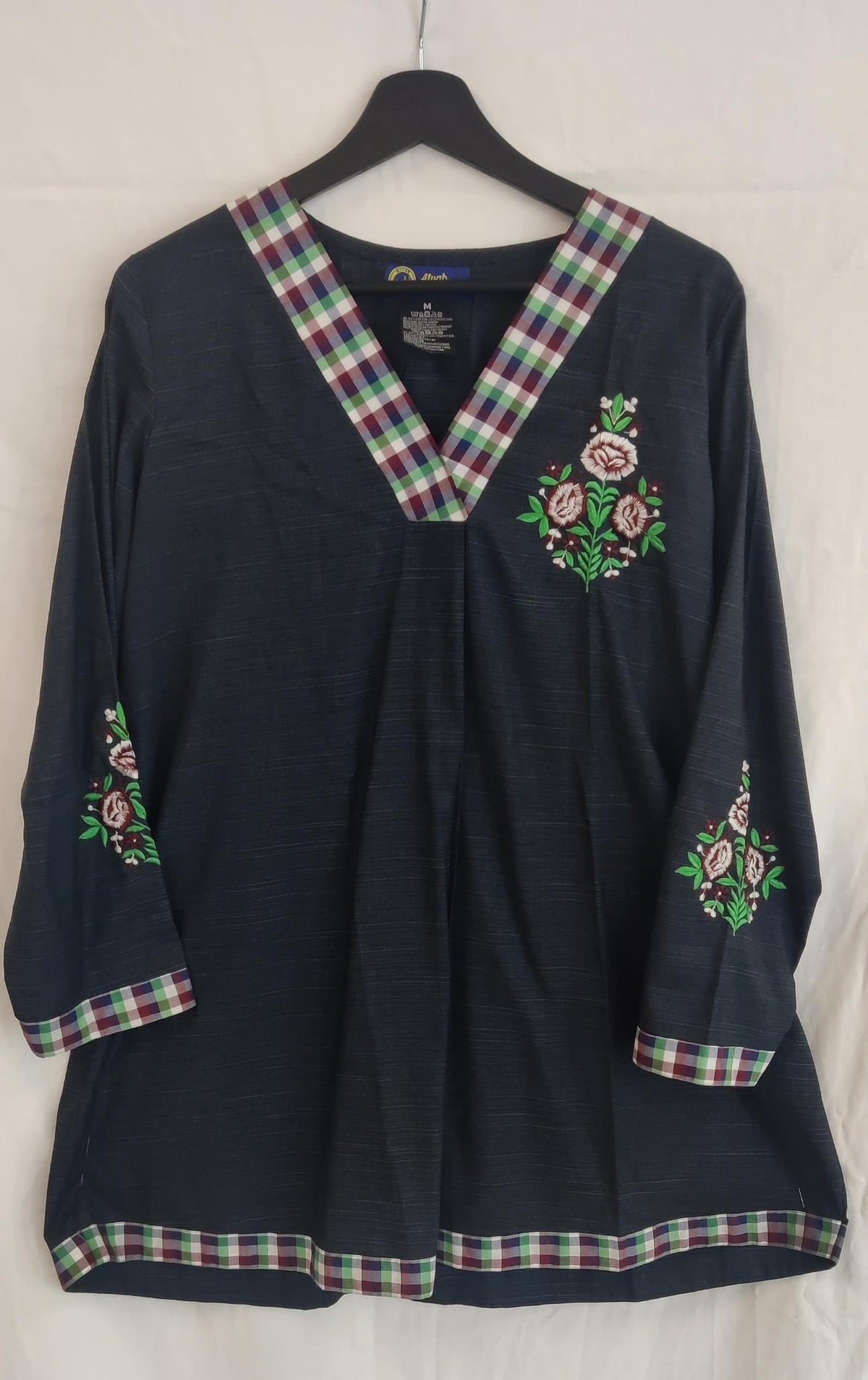 A line short shirt with embroidered bunch on sleeves and pocket place.