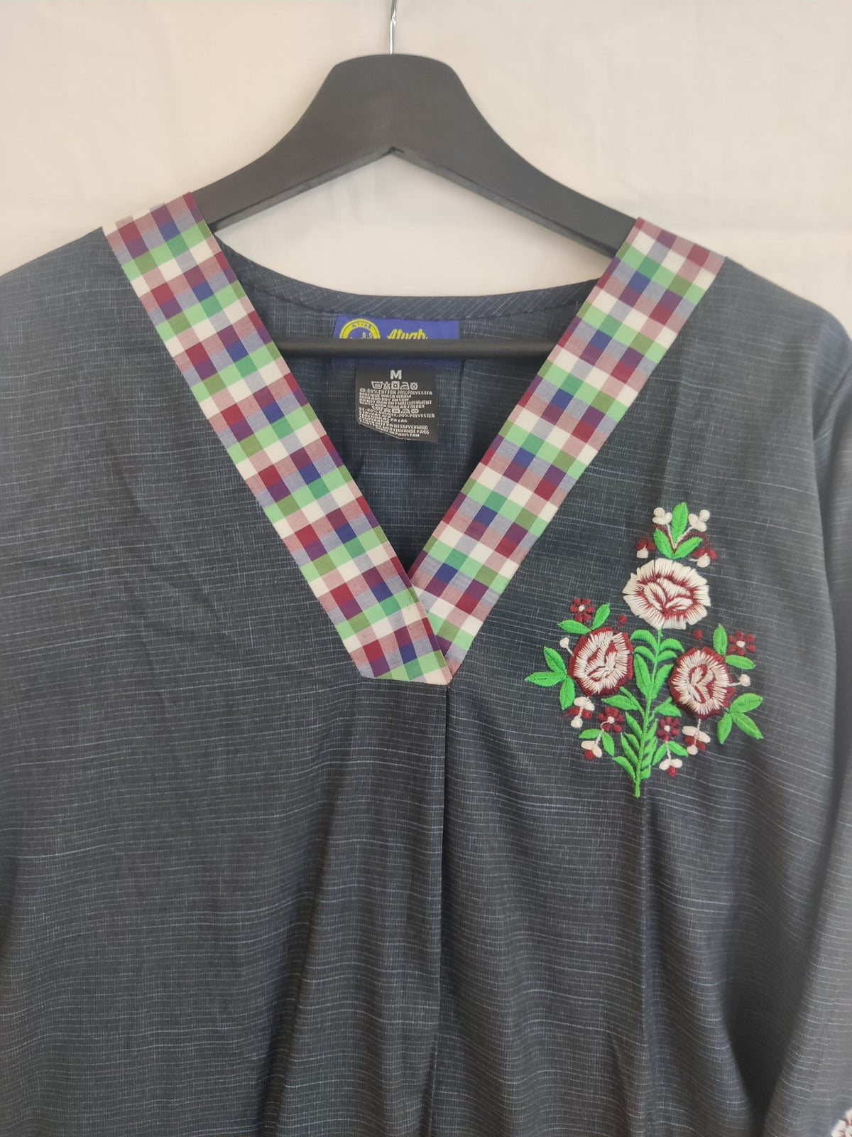 A line short shirt with embroidered bunch on sleeves and pocket place.